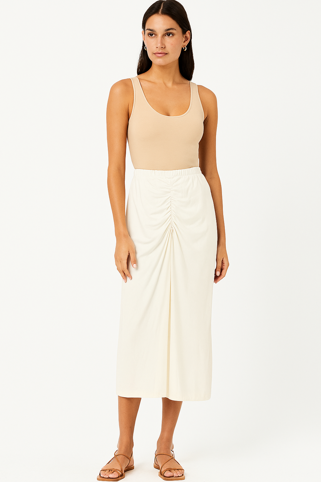 Woman wearing a beige tank top and white skirt on a white background