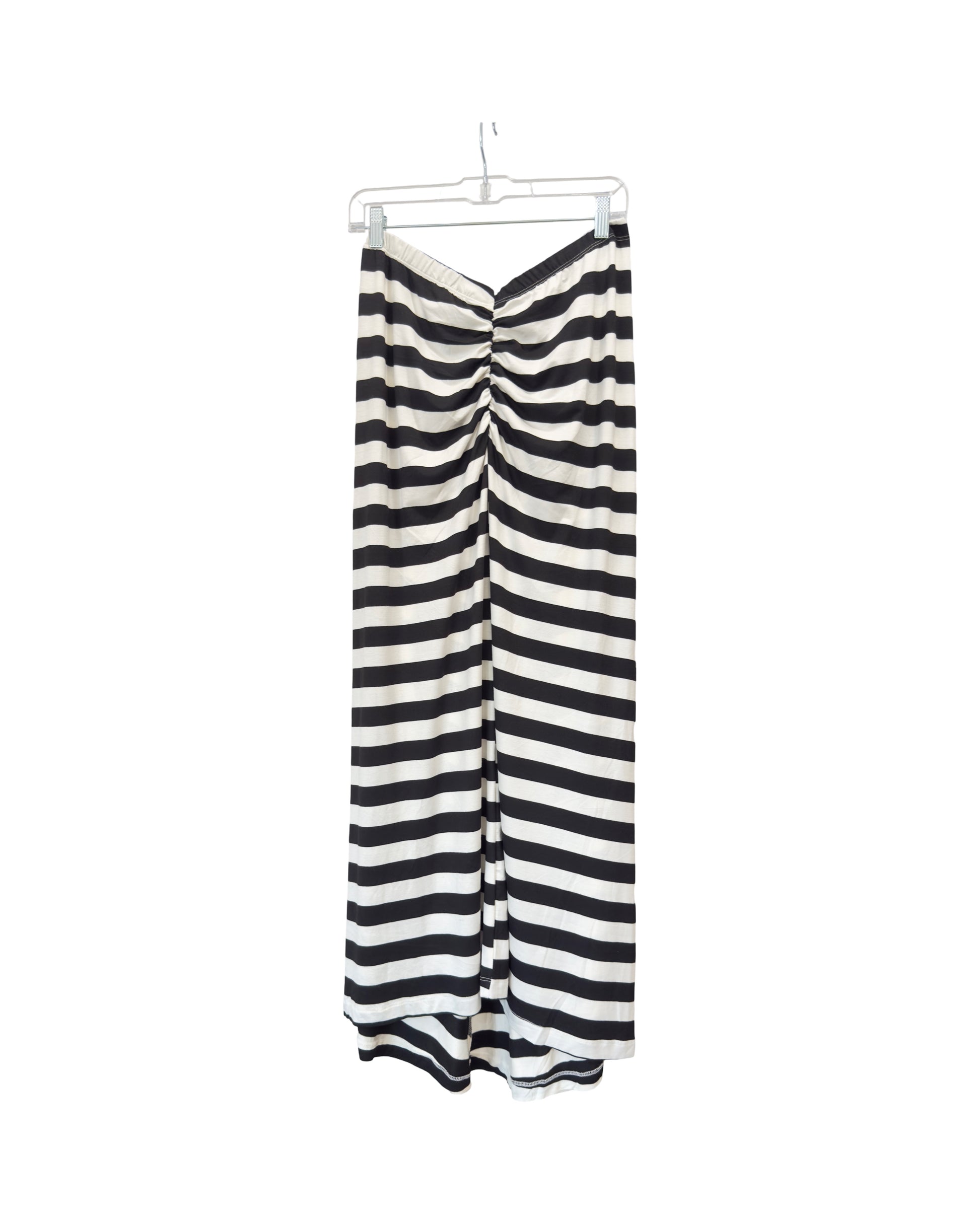 Black and white striped pants on a hanger against a white background